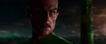 Movie still from “Green Lantern” (2011), directed by Martin Campbell – A man's face with green eyes; Close Up shot, Low angle