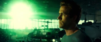 Movie still from “Green Lantern” (2011), directed by Martin Campbell – A person in a room with a helicopter in the background; Close Up shot, Low angle