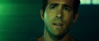 Movie still from “Green Lantern” (2011), directed by Martin Campbell – A man's face in the dark; Close Up shot, High angle