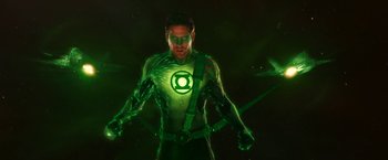Movie still from “Green Lantern” (2011), directed by Martin Campbell – A man in a green lantern costume standing in the dark; Medium shot, Over the shoulder angle