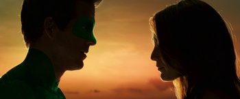 Movie still from “Green Lantern” (2011), directed by Martin Campbell – A man and a woman face to face in front of a sunset; Close Up shot, Low angle