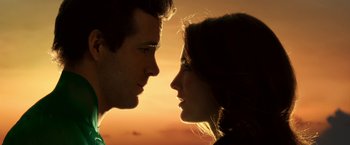 Movie still from “Green Lantern” (2011), directed by Martin Campbell – A man and a woman face to face in front of a sunset; Close Up shot, Low angle