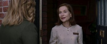 Movie still from “Greta” (2018), directed by Neil Jordan – A woman standing in front of a brick wall; Close Up shot, Over the shoulder angle