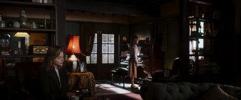 Movie still from “Greta” (2018), directed by Neil Jordan – A woman standing in front of a piano in a living room; Wide shot, Low angle