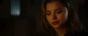 Movie still from “Greta” (2018), directed by Neil Jordan – A person wearing a plaid shirt; Close Up shot, Low angle