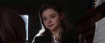 Movie still from “Greta” (2018), directed by Neil Jordan – A person wearing a jacket; Close Up shot, Over the shoulder angle