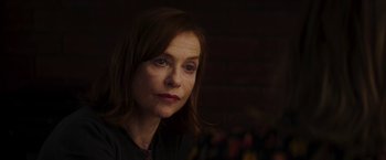 Movie still from “Greta” (2018), directed by Neil Jordan – A person wearing a black shirt; Close Up shot, Over the shoulder angle