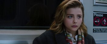 Movie still from “Greta” (2018), directed by Neil Jordan – A woman with long brown hair wearing a jacket; Close Up shot, Low angle