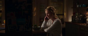 Movie still from “Greta” (2018), directed by Neil Jordan – A woman sitting at a table talking on a cell phone; Medium shot, Over the shoulder angle
