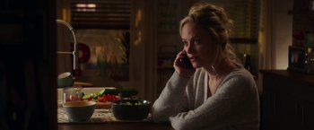 Movie still from “Greta” (2018), directed by Neil Jordan – A woman sitting at a table talking on a phone; Medium shot, Over the shoulder angle