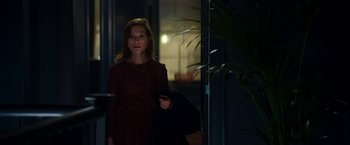 Movie still from “Greta” (2018), directed by Neil Jordan – A woman standing in front of a building at night; Medium shot, Over the shoulder angle