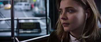 Movie still from “Greta” (2018), directed by Neil Jordan – A person sitting on a bus; Close Up shot, Low angle