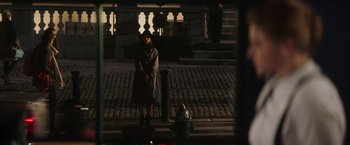 Movie still from “Greta” (2018), directed by Neil Jordan – A woman standing next to a fire hydrant on the side of the street; Wide shot, High angle