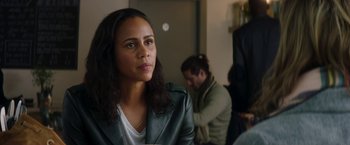 Movie still from “Greta” (2018), directed by Neil Jordan – A woman in a leather jacket looking to her left; Close Up shot, Over the shoulder angle