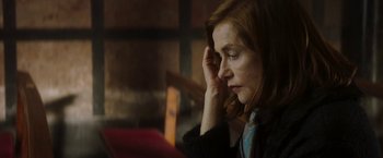 Movie still from “Greta” (2018), directed by Neil Jordan – A woman sitting in front of an open book; Close Up shot, Low angle