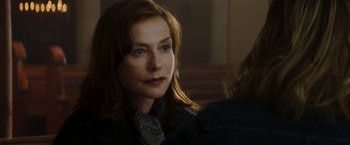 Movie still from “Greta” (2018), directed by Neil Jordan – A person wearing a suit and tie; Close Up shot, Over the shoulder angle