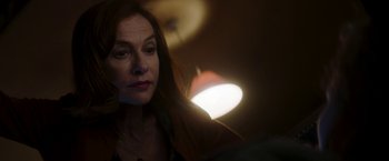Movie still from “Greta” (2018), directed by Neil Jordan – A woman's face in a dark room; Close Up shot, Over the shoulder angle