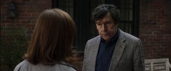 Movie still from “Greta” (2018), directed by Neil Jordan – A man and a woman standing next to each other in front of a building; Close Up shot, Over the shoulder angle