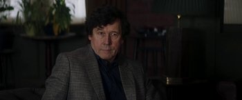 Movie still from “Greta” (2018), directed by Neil Jordan – A person wearing a suit; Close Up shot, Over the shoulder angle