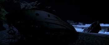 Movie still from “I Know What You Did Last Summer” (1997), directed by Jim Gillespie – A boat in the water at night with a rock formation in the background; Extreme Wide shot, High angle