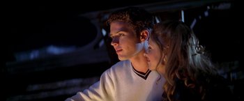 Movie still from “I Know What You Did Last Summer” (1997), directed by Jim Gillespie – A man and a woman looking at something on a table; Close Up shot, Low angle