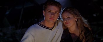 Movie still from “I Know What You Did Last Summer” (1997), directed by Jim Gillespie – A man and a woman pose for a picture; Close Up shot, Low angle