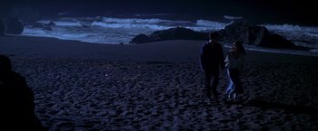 Movie still from “I Know What You Did Last Summer” (1997), directed by Jim Gillespie – A man walking on the beach at night; Extreme Wide shot, High angle