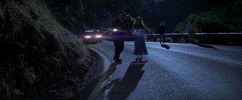 Movie still from “I Know What You Did Last Summer” (1997), directed by Jim Gillespie – A man and a woman walking down a street at night; Wide shot, High angle