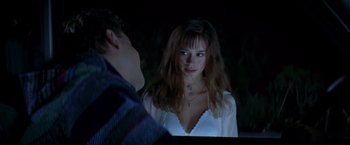 Movie still from “I Know What You Did Last Summer” (1997), directed by Jim Gillespie – A woman looking at a man in the dark; Medium shot, Over the shoulder angle
