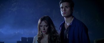 Movie still from “I Know What You Did Last Summer” (1997), directed by Jim Gillespie – A man and a woman standing next to each other in the dark; Medium shot, Low angle