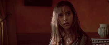 Movie still from “I Know What You Did Last Summer” (1997), directed by Jim Gillespie – A young woman with long hair and a necklace; Close Up shot, Over the shoulder angle