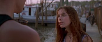 Movie still from “I Know What You Did Last Summer” (1997), directed by Jim Gillespie – A woman with long red hair looking to her left; Close Up shot, Over the shoulder angle
