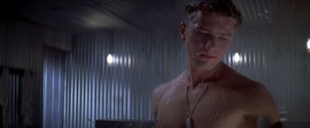 Movie still from “I Know What You Did Last Summer” (1997), directed by Jim Gillespie – A man in the shower with water pouring on his face; Medium shot, Low angle