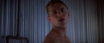 Movie still from “I Know What You Did Last Summer” (1997), directed by Jim Gillespie – A young man is taking a shower in the bathroom; Close Up shot, Low angle