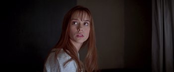 Movie still from “I Know What You Did Last Summer” (1997), directed by Jim Gillespie – A woman with long red hair and a white sweater; Close Up shot, Low angle