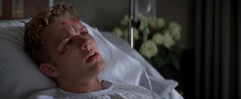 Movie still from “I Know What You Did Last Summer” (1997), directed by Jim Gillespie – A man in a hospital bed with a bleeding eye; Close Up shot, Low angle
