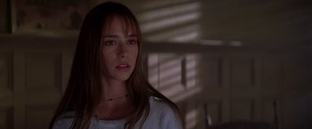 Movie still from “I Know What You Did Last Summer” (1997), directed by Jim Gillespie – A woman with long brown hair wearing a white sweater; Close Up shot, Over the shoulder angle