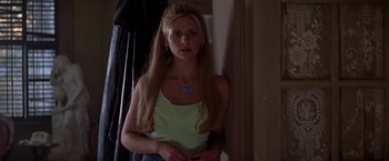 Movie still from “I Know What You Did Last Summer” (1997), directed by Jim Gillespie – A woman with long blonde hair wearing a white tank top; Close Up shot, Over the shoulder angle
