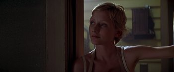 Movie still from “I Know What You Did Last Summer” (1997), directed by Jim Gillespie – A woman with short blonde hair looking out of a window; Close Up shot, Over the shoulder angle