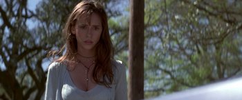 Movie still from “I Know What You Did Last Summer” (1997), directed by Jim Gillespie – A beautiful young lady standing next to a tree; Close Up shot, Low angle