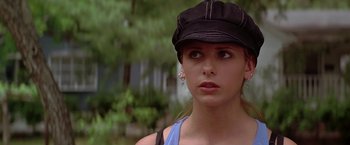 Movie still from “I Know What You Did Last Summer” (1997), directed by Jim Gillespie – A woman wearing a black hat looking to her left; Close Up shot, High angle