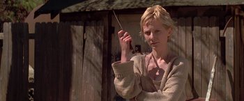 Movie still from “I Know What You Did Last Summer” (1997), directed by Jim Gillespie – A woman holding a pipe in her hand; Close Up shot, Low angle