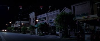 Movie still from “I Know What You Did Last Summer” (1997), directed by Jim Gillespie – A street light hanging over a street at night; Extreme Wide shot, High angle
