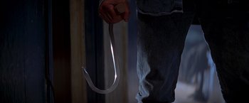 Movie still from “I Know What You Did Last Summer” (1997), directed by Jim Gillespie – A person holding a metal hook in their hand; Extreme Close Up shot, High angle