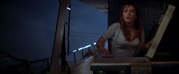 Movie still from “I Know What You Did Last Summer” (1997), directed by Jim Gillespie – A woman standing on a boat in the night time; Medium shot, Low angle