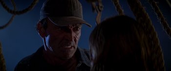 Movie still from “I Know What You Did Last Summer” (1997), directed by Jim Gillespie – An older man wearing a hat talking to a young woman; Close Up shot, Over the shoulder angle