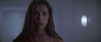 Movie still from “I Know What You Did Last Summer” (1997), directed by Jim Gillespie – A woman with a necklace is looking at the camera; Close Up shot, Over the shoulder angle