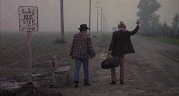 Movie still from “Hair” (1979), directed by Milos Forman – Two men walking down a dirt road near a train track; Wide shot, Low angle