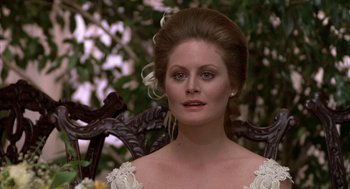 Movie still from “Hair” (1979), directed by Milos Forman – A person wearing a dress; Close Up shot, Over the shoulder angle