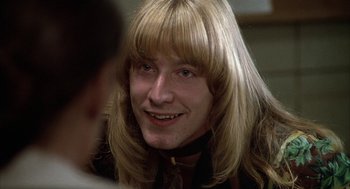 Movie still from “Hair” (1979), directed by Milos Forman – A person with long blonde hair; Close Up shot, Over the shoulder angle